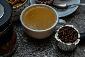Coffee cup on rock table. Top view with morning sunlight