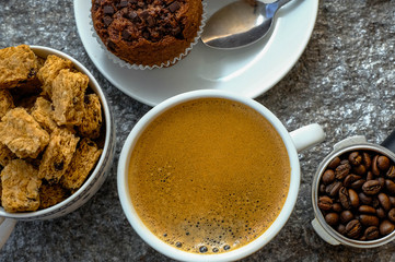 Coffee cup on rock table. Top view with morning sunlight