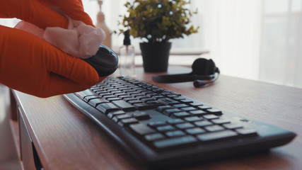 Close up hands disinfecting laptop keyboard with antiseptic spray and wet wipe in gloves virus antibacterial pandemic laptop sanitary stay at home infection clean sanitizing precaution coronavirus