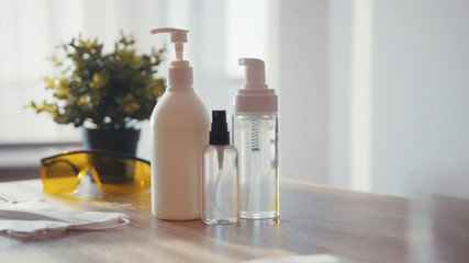 Close up three types of sanitizers bottles on table for people washing hands to help stop coronavirus covid-19 hygienic health care antibacterial gel medicine finger corona hospital slow motion