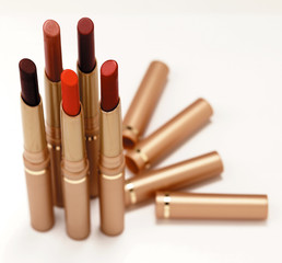 Five shades of red lipsticks on a white background 