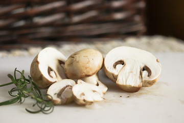 mushrooms on a wooden table and rosemary leaves