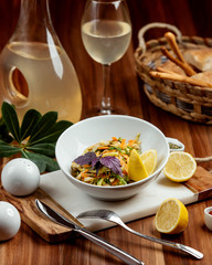 vegetable salad topped with orange lemon zest and lemon slices