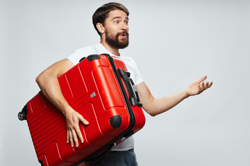 portrait of a man holding a suitcase