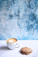 Cup of cappucino with cookies