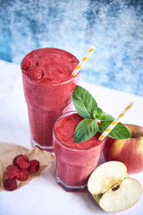 Close up of red smoothie with raspberries and apples