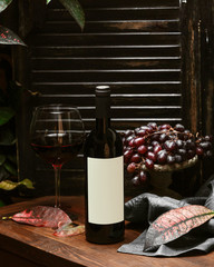 a bottle of red wine and a glass of red wine _