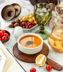 a bowl of lentil soup served on wooden serving pan