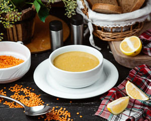 a bowl of lentil soup served with lemon slices