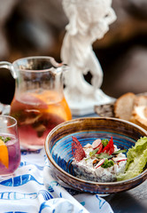 a bowl of vegetable salad with mayonnaise and a jug of cocktail