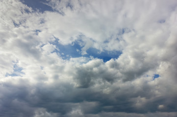 Obraz premium The sky at sunset. Cumulus clouds lit by the rays of the setting sun.
