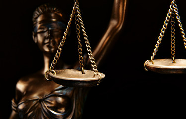 Bronze Themis statue - symbol of Justice - Isolated on black