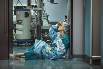 Woman surgeon looking sadness fatigue after surgery copyspace stress depression guilt unhappy...