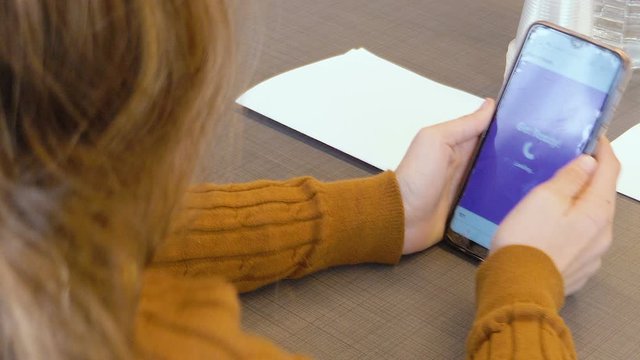 Tel Aviv, Israel - Dec 27, 2019: Israeli elementary caucasian teen girl plays "Kahoot!" with her phone in a classroom lesson. An online game-based learning platform used as educational technology.