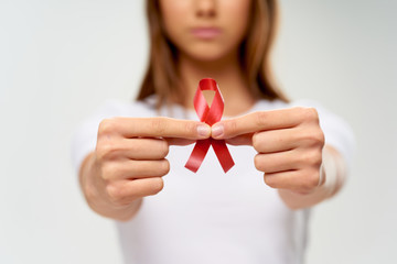 young woman holding a red heart