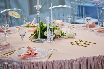 Beautiful table setting on Coral color tablecloth. Ready to serve lunch