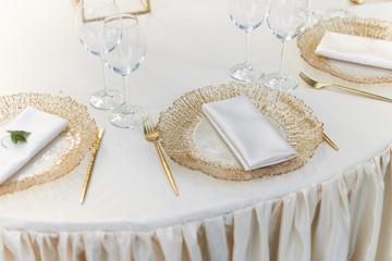Beautiful table setting on soft beige color tablecloth. Ready to serve lunch