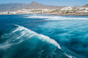 Tenerife surfers on the beach of Las Americas ride the waves
