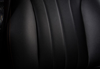the interior of the car is covered with handmade genuine leather. Close-up of leather car seat...