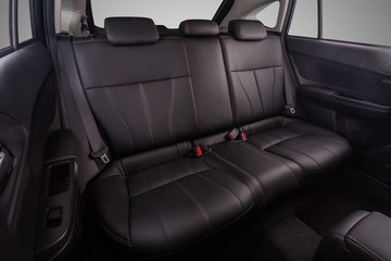 the interior of the car is covered with handmade genuine leather. back row of car seats. general view. Car doors are visible