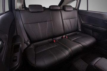 Naklejka premium the interior of the car is covered with handmade genuine leather. back row of car seats. general view. Car doors are visible