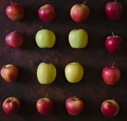 Background of red and green apples placed in a row.