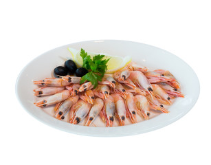 A portion of boiled shrimp with lemon and olives on a white plate. on white background