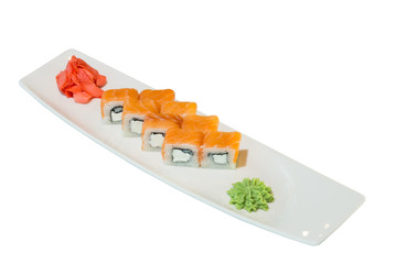 A portion of sushi with red fish on a white plate. Pickled ginger and wasabi. on white background