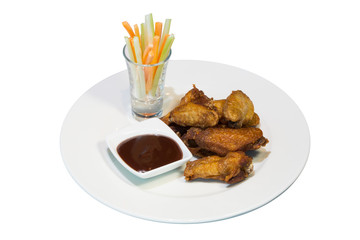 A portion of fried chicken wings with barbecue sauce on a white plate. on white background