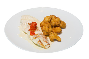 A dish of Turkey stewed in cream sauce and chicken nuggets fried in batter on a white plate. on white background
