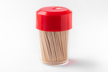 Toothpicks in a box on a white background. Closed bottle with toothpicks