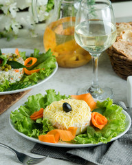 a plate of mimosa salas garnished with carrot slices and lettuce