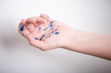 Artist hands covered in paint on light background