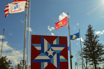 Interwoven Star Staples Veteran Park MN Flags above