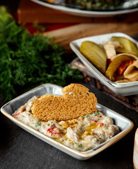 a serving of side dish with vegetables topped with bread toast