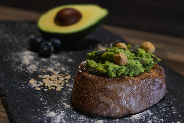 Vegan breakfast with avocado toast, pumpkin seeds and hazelnuts
