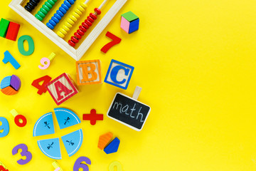 Colorful math fractions on yellow background. Blocks with title School on the table. Interesting, fun math for kids. Education, back to school concept	
