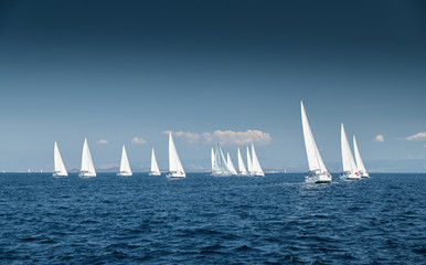 The race of sailboats, a sail regatta, reflection of sails on water, Intense competition, number of...