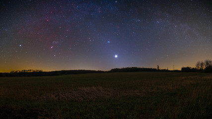 Night sky including the Orion constellation, the bright planet Venus, and the Zodiacal light photographed from Bullau in the Odenwald in Germany.