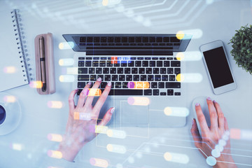 Double exposure of woman hands working on computer and data theme hologram drawing. Top View. Technology concept.