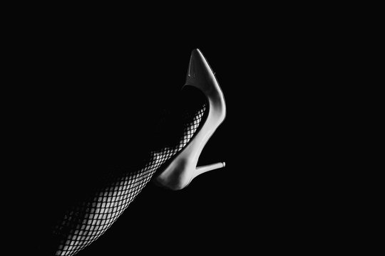 A heel on a person's leg. Heel. Hand in retina. Black and white background.