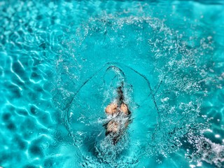 Young Girl jumping in Swimmingpool
