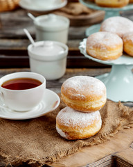 powder sugared custard donuts and black tea