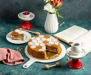 sliced honey cake decorated with sugar powder sprinkles in bee hive shape