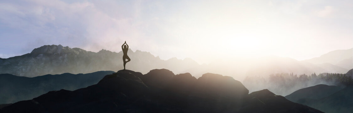 woman doing yoga on top of the mountain