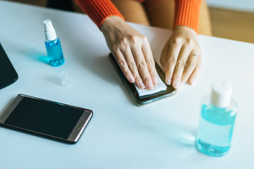 Fototapeta premium Cleaning dirty mobile phone on screen,Preventive measures against coronavirus,Covid-19