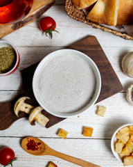 top view of mushroom soup served on wooden board