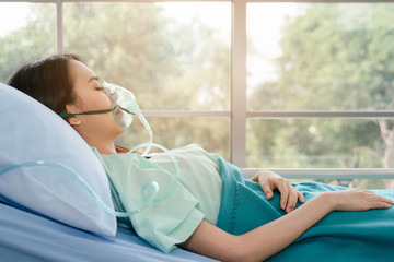 asian woman patient on bed in hospital with wearing oxygen mask