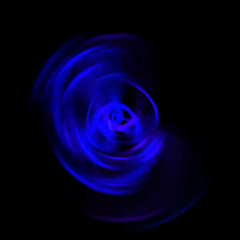 Spinning rays of light isolated on black background. Graphic 2D illustration of glowing colorful light particles in circular motion.