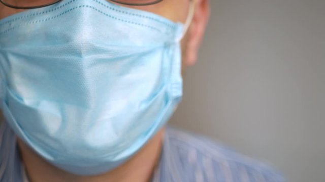 a sad man with virus, covid-19 and mask on his face for antivirus protection taking deep breath, rapid breathing